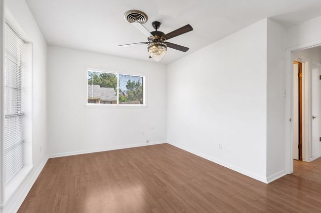 Bedroom 1 with laminate finished floors and a ceiling fan | Image 21