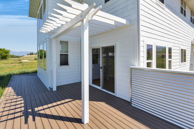 Wooden deck with a pergola and a mountain view | Image 48