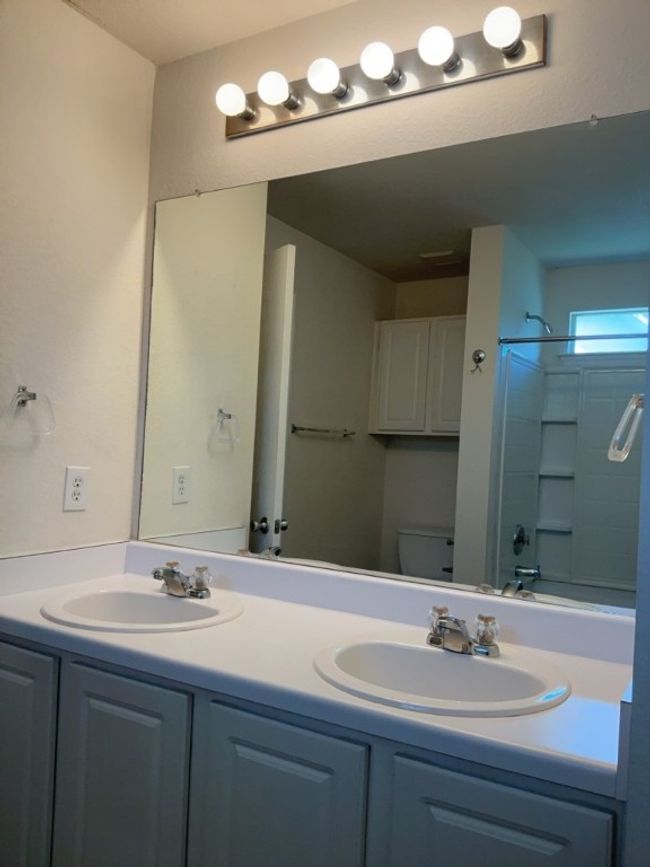Bathroom with double vanity and bathing tub / shower combination | Image 20