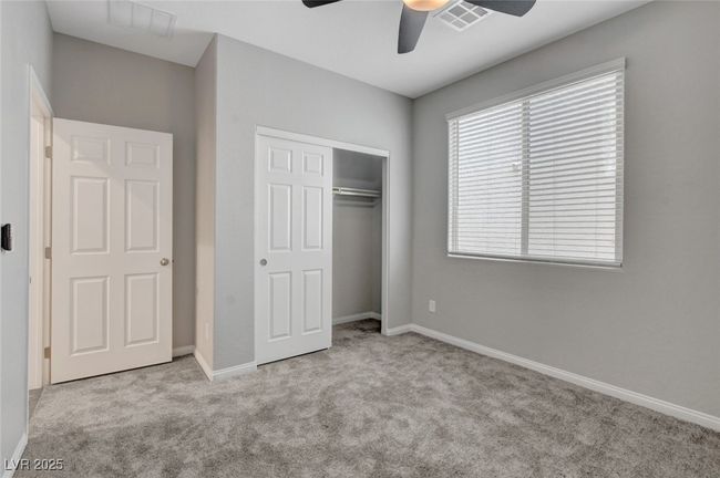 Unfurnished bedroom with carpet floors, a closet, ceiling fan, and baseboards | Image 14