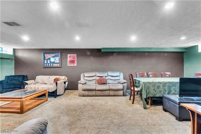 Living room with carpet flooring, a textured ceiling, and recessed lighting | Image 27