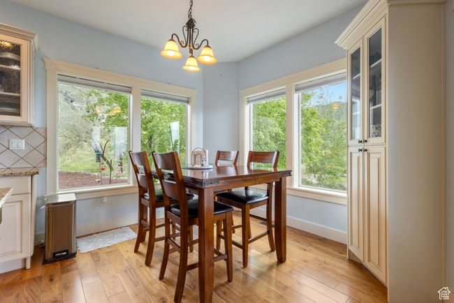 Dining space with plenty of natural light, light wood finished floors, and baseboards | Image 16