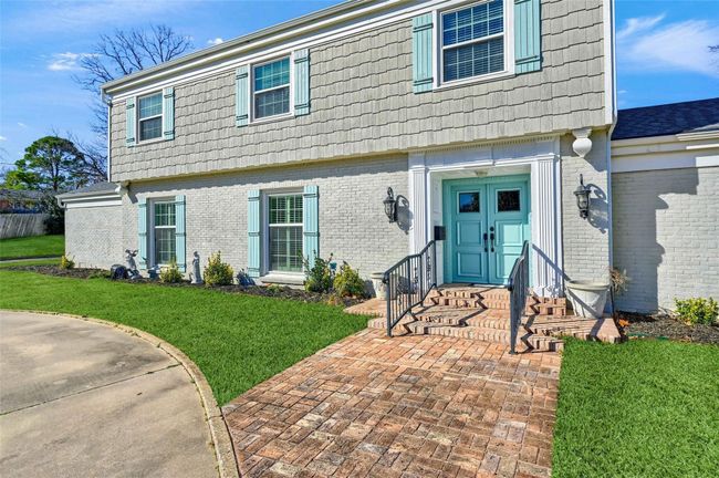 Colonial inspired home with brick siding and a front lawn | Image 5