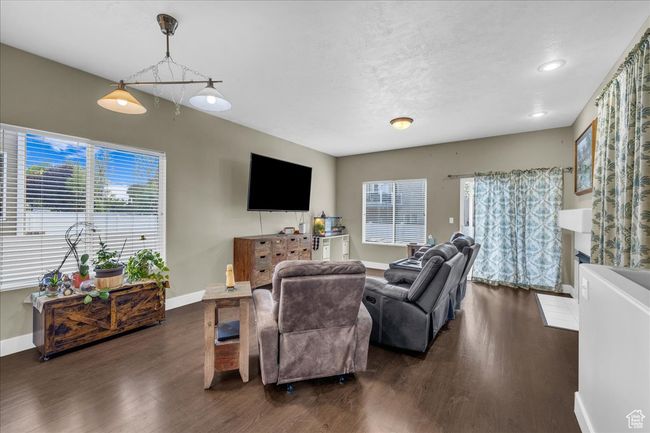 Living room featuring dark wood-style floors, baseboards, and a wealth of natural light | Image 5