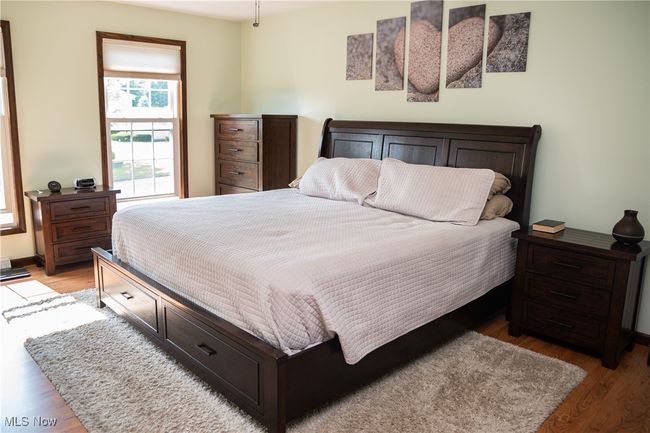 Bedroom with light wood finished floors and baseboards | Image 30