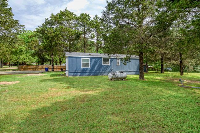 Rear view of house featuring view of scattered trees | Image 6