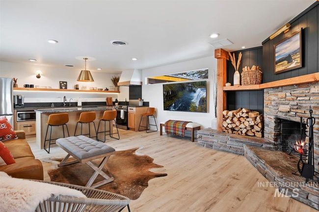 Living room featuring light wood-style floors, a fireplace, and recessed lighting | Image 29
