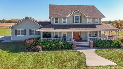 View of front of home featuring covered porch and a front lawn | Image 1