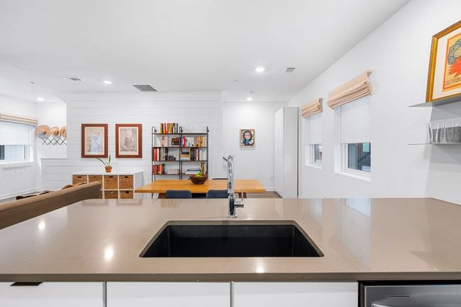 Kitchen featuring open floor plan, a sink, recessed lighting, and visible vents | Image 14
