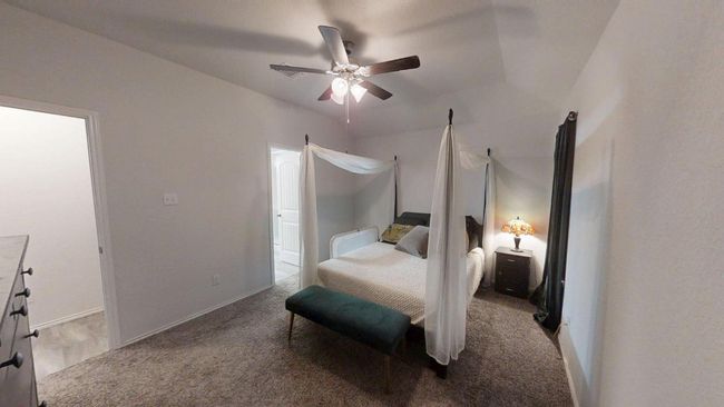 Carpeted bedroom with a ceiling fan | Image 29