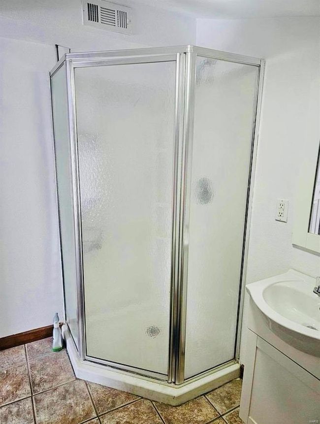 Bathroom with vanity, a shower stall, and visible vents | Image 19