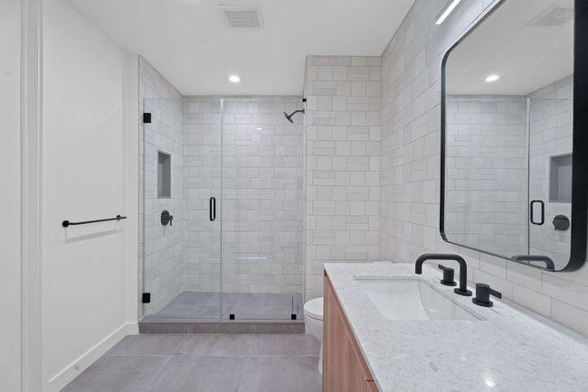 Full bath with vanity, a shower stall, tile patterned floors, and recessed lighting | Image 18