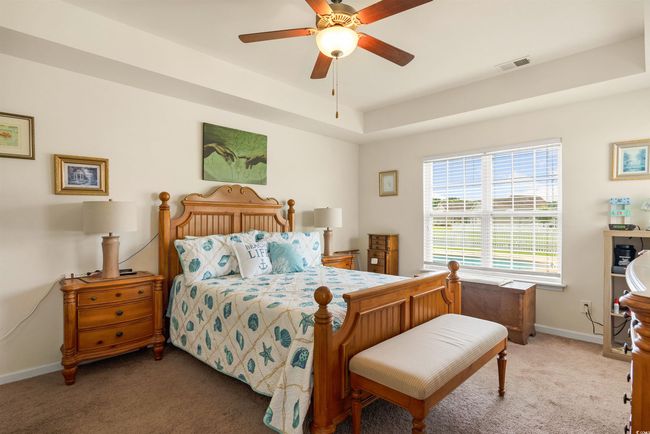 Bedroom with carpet flooring, baseboards, and a ceiling fan | Image 8