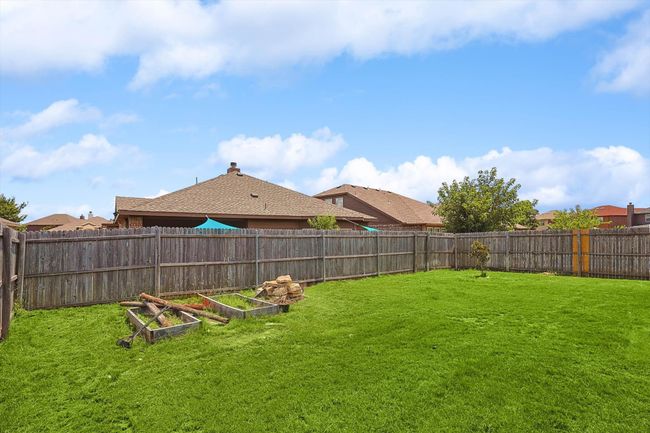 Fenced backyard featuring a garden | Image 34