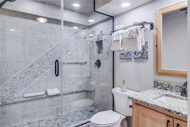 Guest bathroom with walk in shower and granite counters. | Image 25