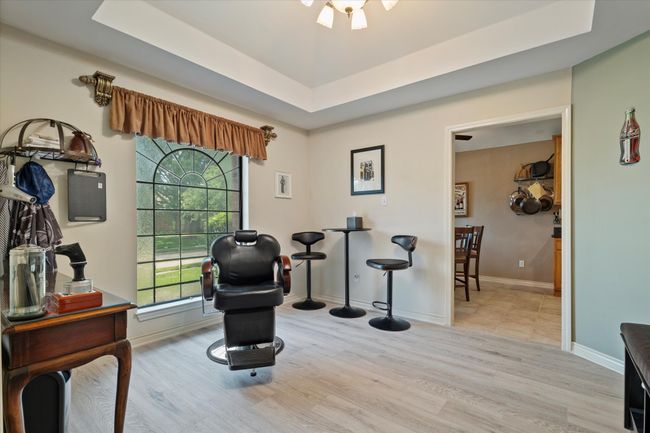 Sitting room with wood finished floors, a raised ceiling, and baseboards | Image 13