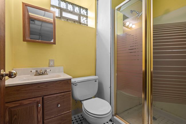 This convenient lower level bath features a walk-in shower, perfect for guests or daily use. | Image 14