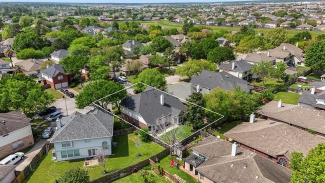 This aerial view, taken from behind the home, showcases the golf course in the distance and highlights the home’s prime location on a quiet cul-de-sac, offering both privacy and scenic surroundings. | Image 38