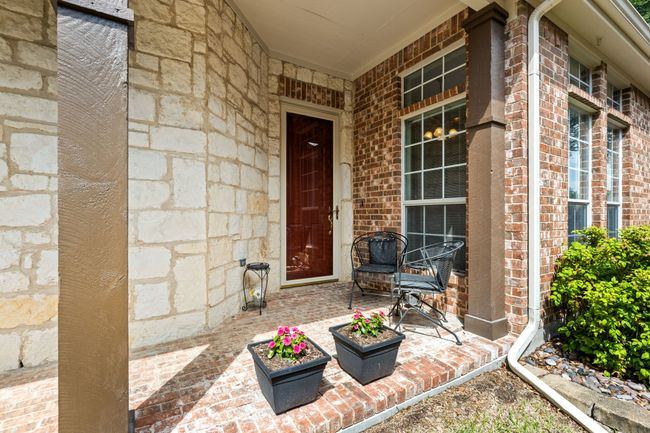 View of exterior entry with brick siding and a porch | Image 33