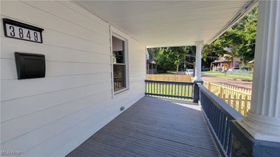 Wooden deck featuring a lawn and a porch | Image 3