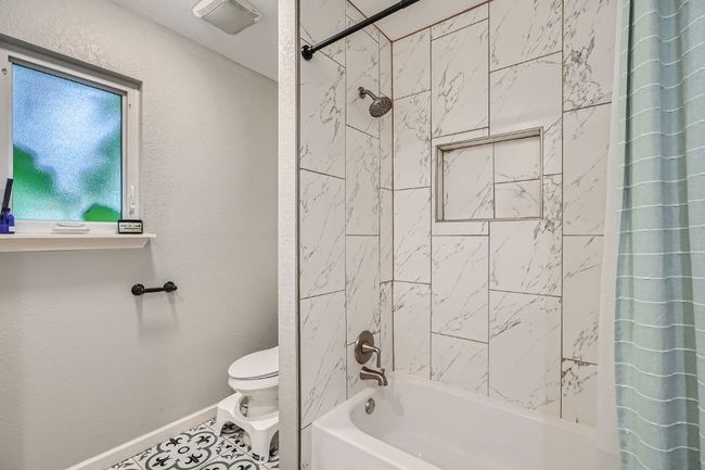 Bathroom with shower / bath combo and tile patterned flooring | Image 24