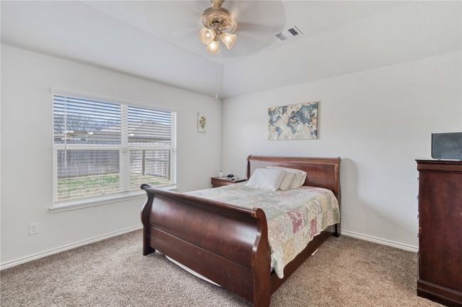 Bedroom featuring vaulted ceiling, light colored carpet, and ceiling fan | Image 18