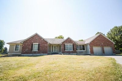 Single story home with a garage and a front yard | Image 1