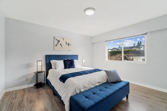 Bedroom featuring baseboards and wood finished floors | Image 13