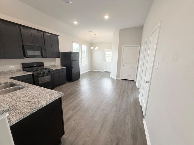 14501 SUGAR PINES DR - Kitchen with all black appliances, refrigerator included | Image 13