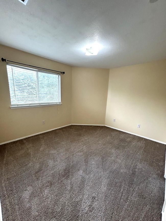 Carpeted empty room with baseboards and a textured ceiling | Image 14