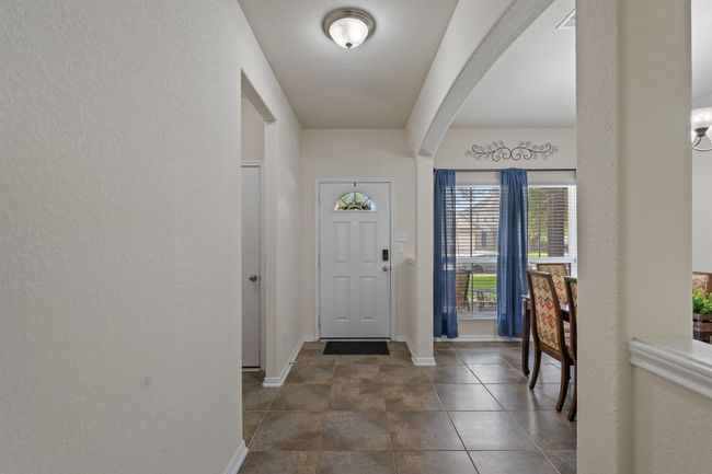 To your left is a storage closet and the door leading to the garage. | Image 8