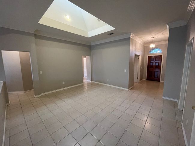 Empty room with crown molding and light tile patterned floors | Image 21