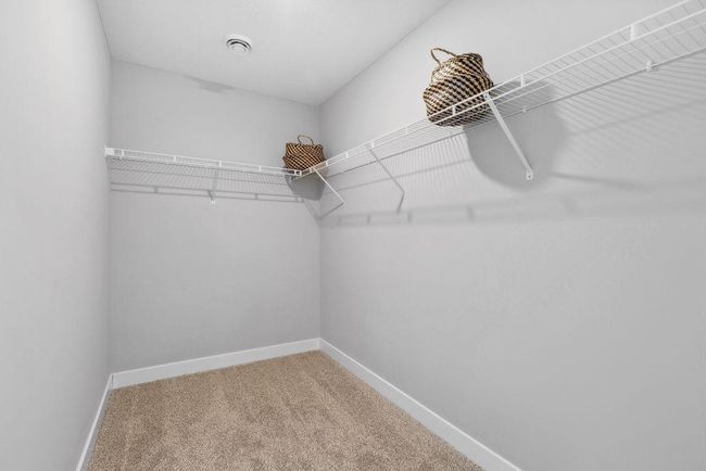 Huge walk-in closet in primary bedroom. Photo of Model home. Colors and options may vary. Ask Sales Agent for details. | Image 27