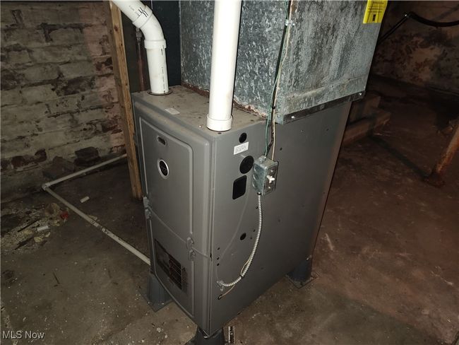 Utility room featuring heating unit | Image 48