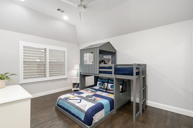 Third bedroom is located on the second floor with plantation shutters, hardwood flooring, vaulted ceiling and upgraded fan with recessed lighting. | Image 29