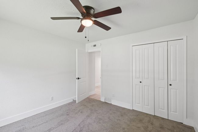 Unfurnished bedroom featuring carpet flooring, a closet, and a ceiling fan | Image 34