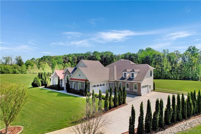 View of front of house with a garage and a front lawn | Image 2