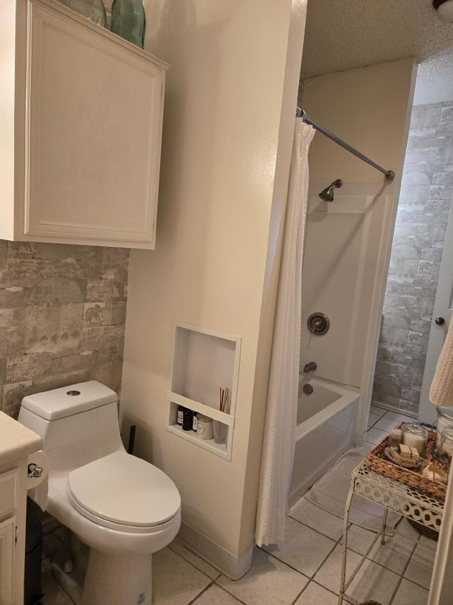Bathroom with shower / bath combo, vanity, and tile patterned floors | Image 6