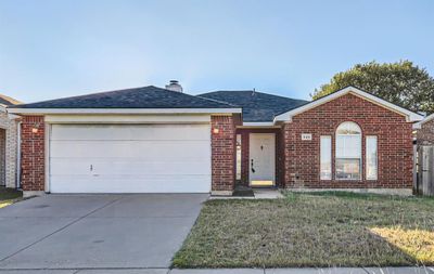 View of front of house featuring a front yard and a garage | Image 1