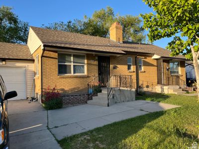 Single story home featuring a front lawn and a garage | Image 2