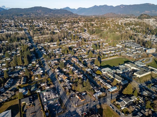 Aerial overview of property's location with a mountainous background and nearby suburban area | Image 18