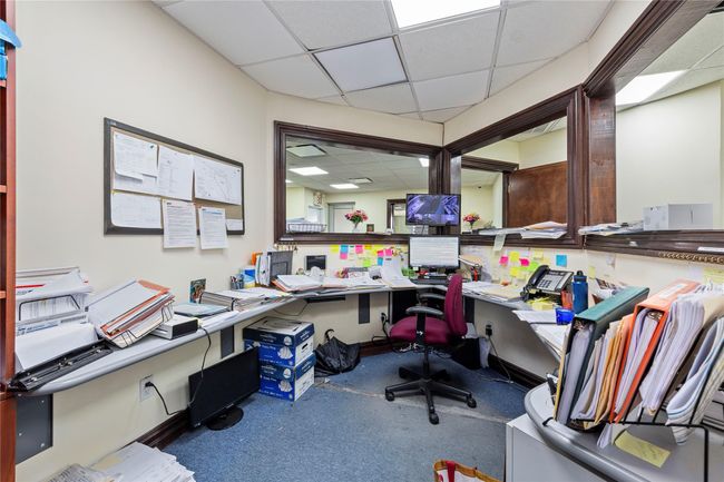 Carpeted office space featuring a drop ceiling | Image 34