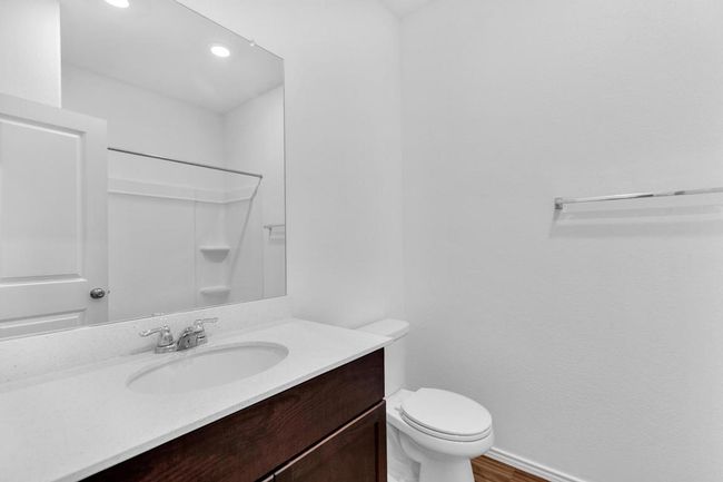 Full bath with a shower, baseboards, toilet, wood finished floors, and vanity | Image 19