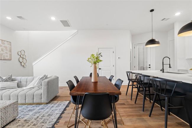 High ceilings, bright natural light, and a thoughtfully designed open floor plan create a welcoming and functional living area. | Image 6