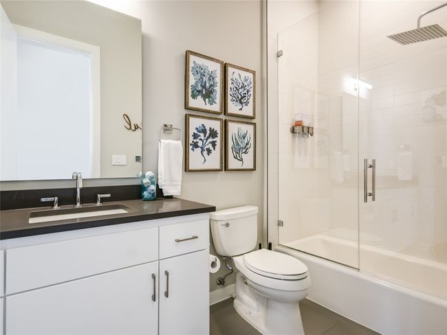 The guest bathroom features a custom-installed glass wall and upgraded shower head. | Image 21