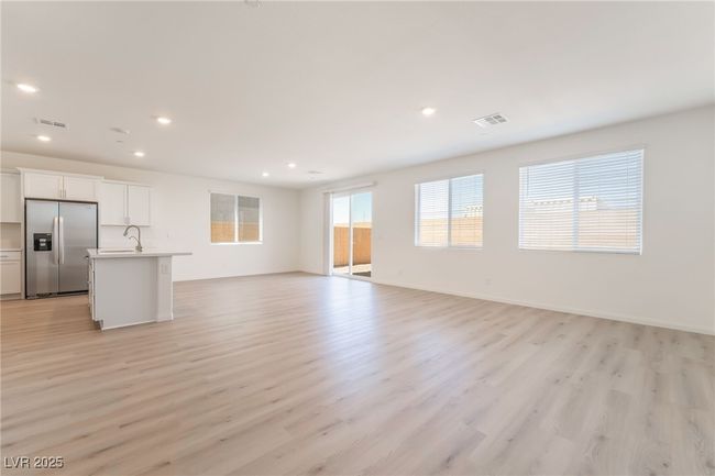 Unfurnished living room featuring light wood-style floors and recessed lighting | Image 4
