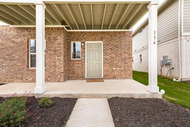 Doorway to property featuring brick siding | Image 6
