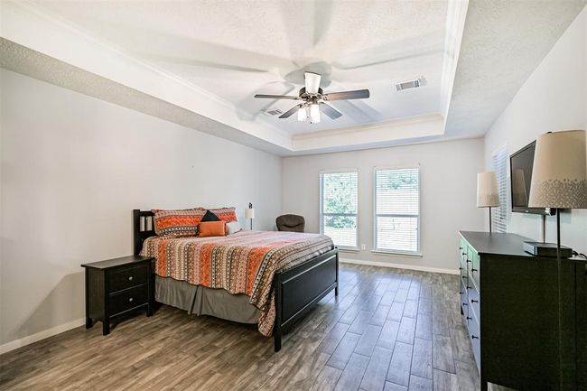Spacious primary bedroom with tray ceiling | Image 10