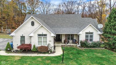 Welcome to this gorgeous custom-built ranch with a spacious finished basement, perfect for relaxing and entertaining. Step out to a backyard oasis with serene views all around-your peaceful retreat awaits! | Image 1