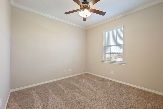 Empty room featuring carpet floors, ornamental molding, and ceiling fan | Image 17
